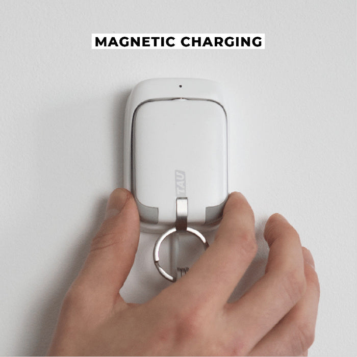 TAU® - Always-charged power bank - Charcoal Black - Compact white power bank with magnetic charging and integrated keyring attachment in hand. - Rolling Square